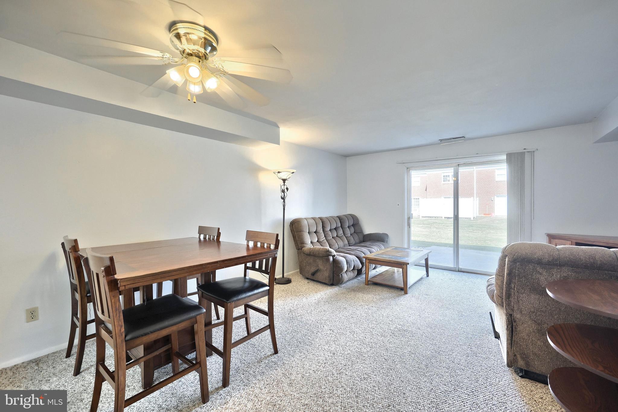 1640 Devers Road, Unit D York, PA 17404 - Photo 13 of 22 a living room with furniture a chandelier and a large window