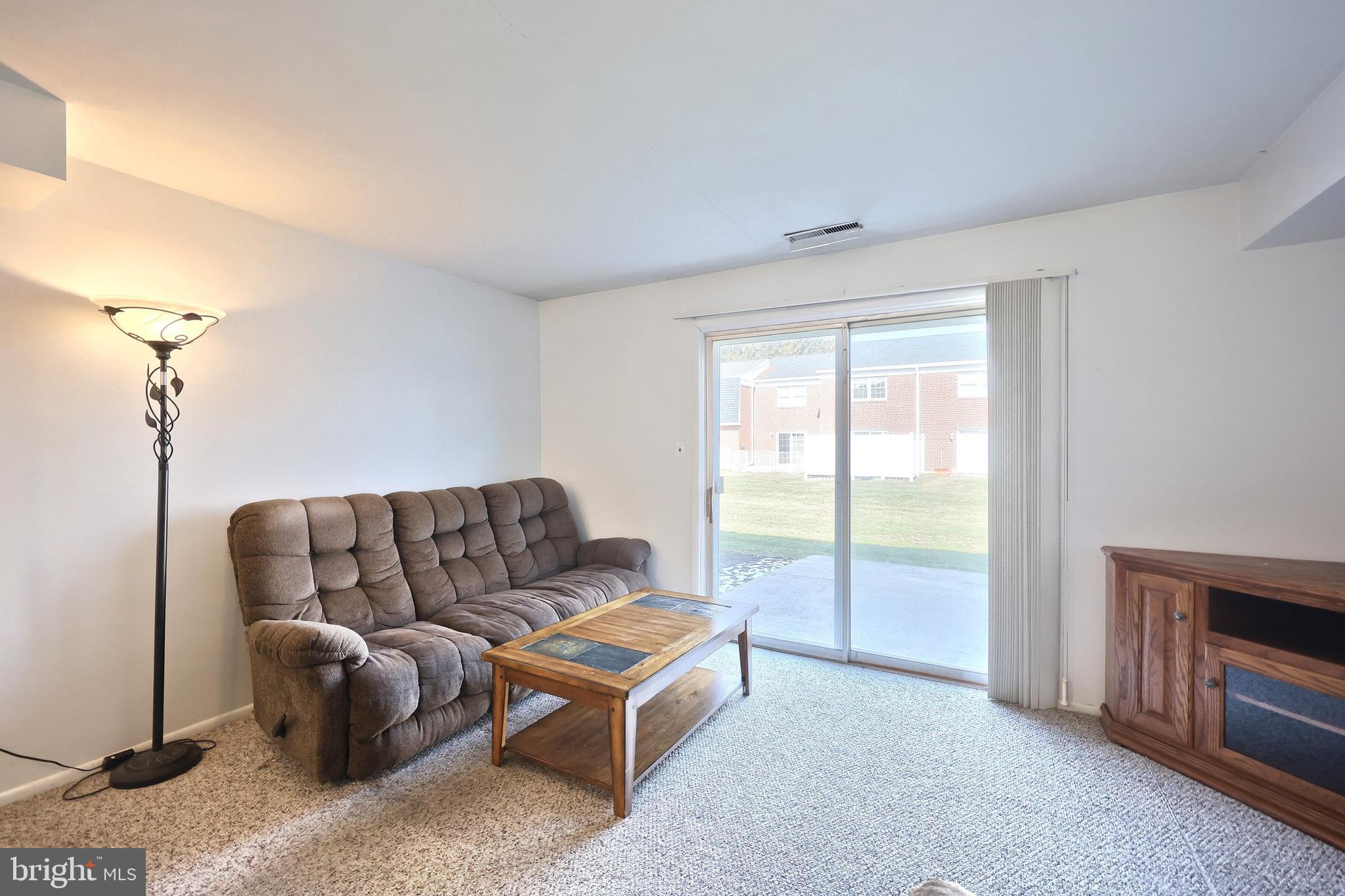 1640 Devers Road, Unit D York, PA 17404 - Photo 16 of 22 a living room with furniture and a floor to ceiling window