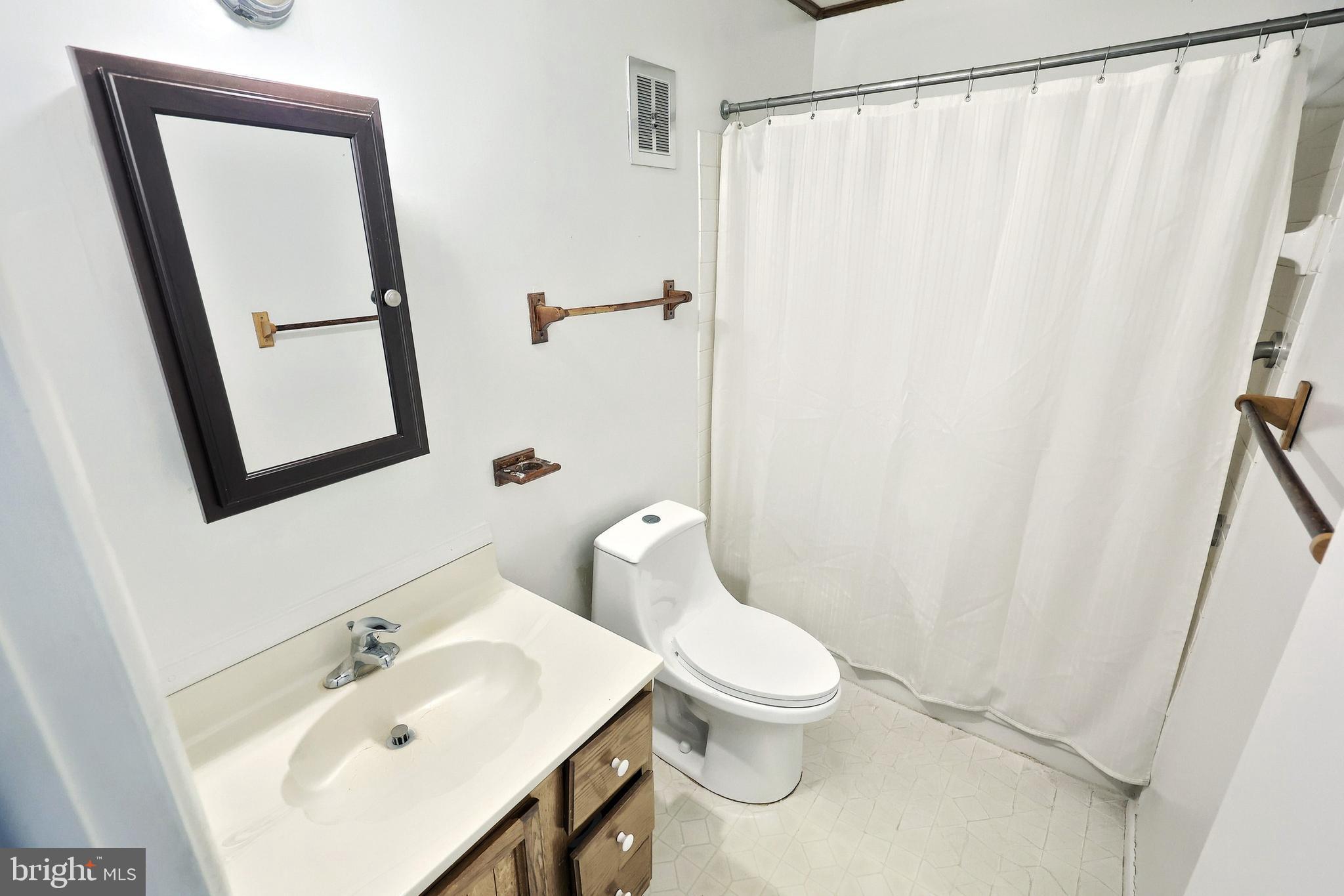 1640 Devers Road, Unit D York, PA 17404 - Photo 21 of 22 a white toilet sitting next to a bathroom sink