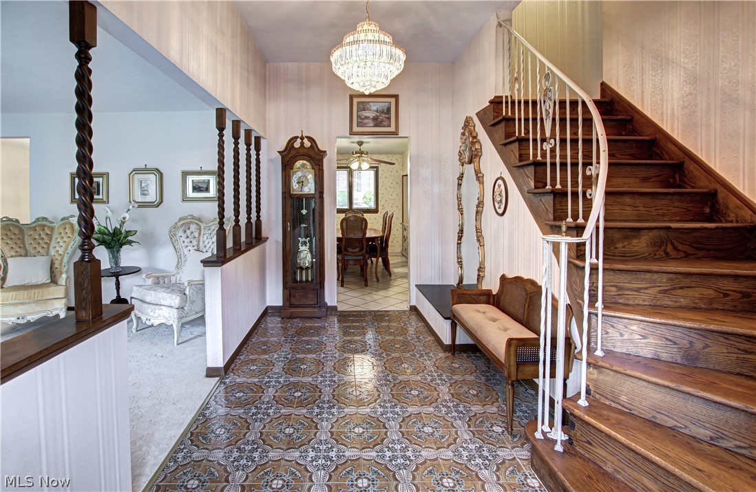6013 Rousseau Drive Parma, OH 44129 - Photo 14 of 50 Carpeted foyer featuring ceiling fan with notable chandelier