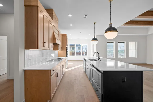a large kitchen with stainless steel appliances granite countertop a sink and dishwasher