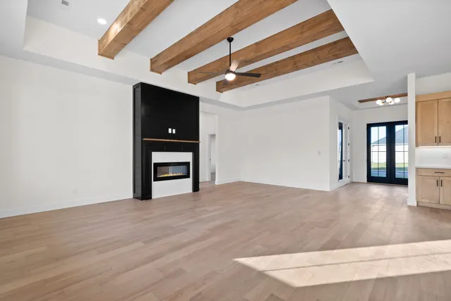 a view of an empty room with closet and a window