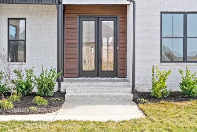 a front view of a house with potted plants