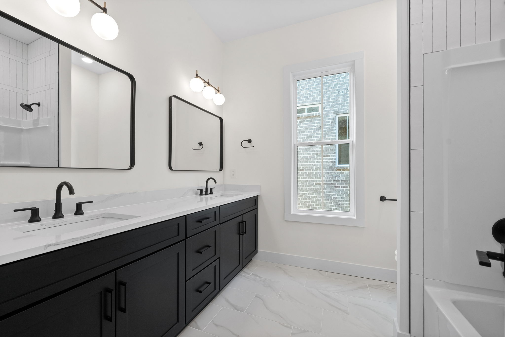 1120 Jacobs Court Joelton, TN 37080 - Photo 31 of 44 a bathroom with a double vanity sink a mirror and a bathtub