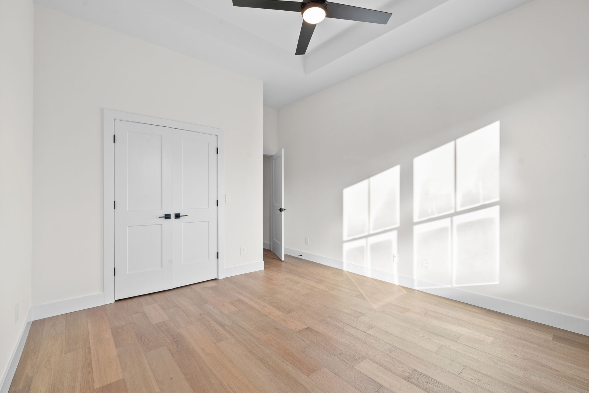 1120 Jacobs Court Joelton, TN 37080 - Photo 35 of 44 an empty room with wooden floor cabinet and windows