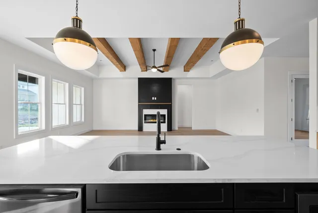 a kitchen with a sink and a mirror