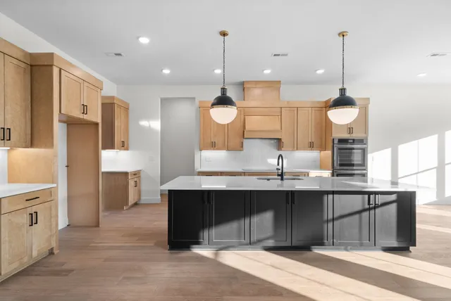a kitchen with counter top space sink and refrigerator