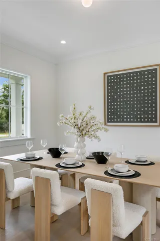 a kitchen with a table chairs stove and cabinets