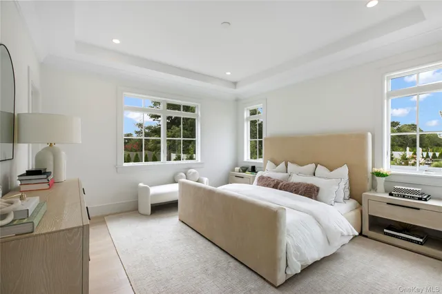 a bedroom with a bed and large window