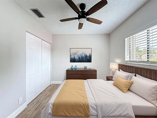 a bedroom with a large bed and a window