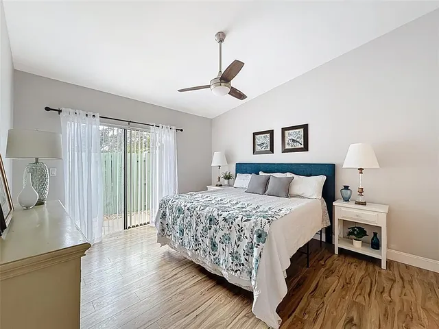 a spacious bedroom with a bed and a chandelier