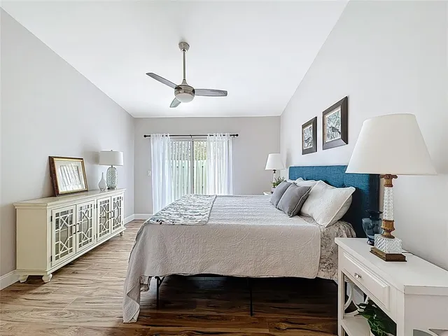 a bedroom with a bed and wooden floor