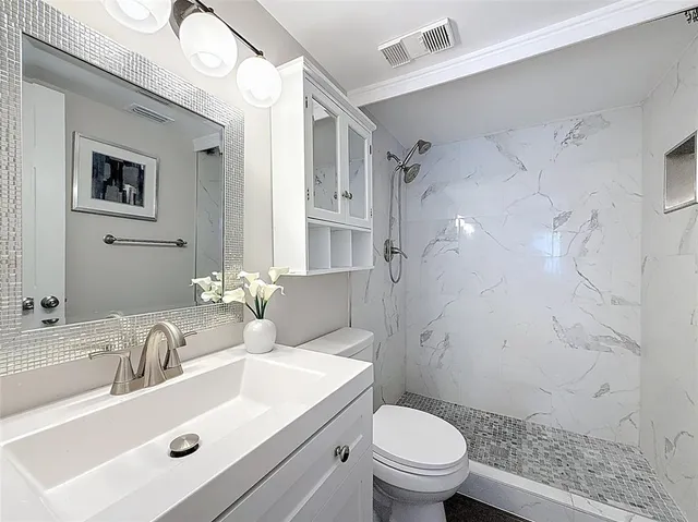 a bathroom with a sink toilet and shower