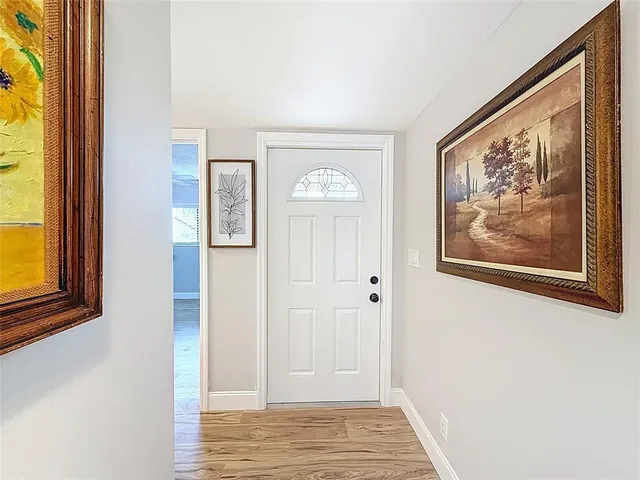 a view of an entryway with wooden floor