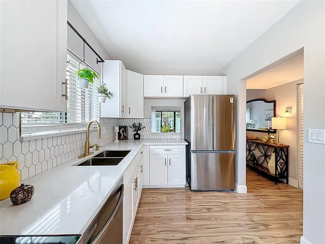 a kitchen with a refrigerator and a sink