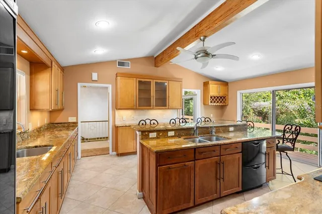a kitchen with stainless steel appliances granite countertop a sink counter space and wooden floor