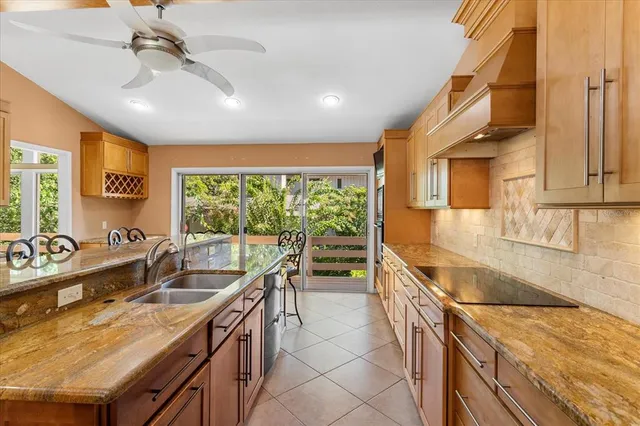a kitchen with stainless steel appliances granite countertop a sink and cabinets