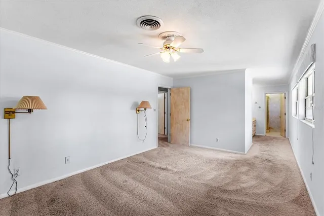 a view of walk in closet with empty racks