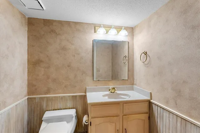 a view of an empty room with wooden walls and windows