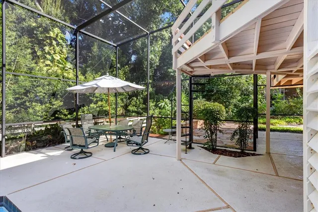a view of a chairs and table in the balcony