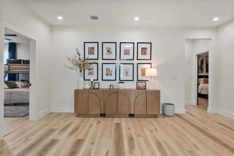 a spacious bedroom with a bed and a view of cabinet