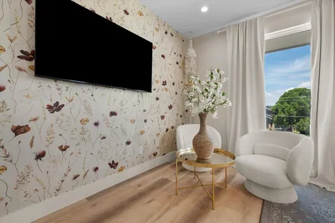 a living room with furniture fireplace and flat screen tv