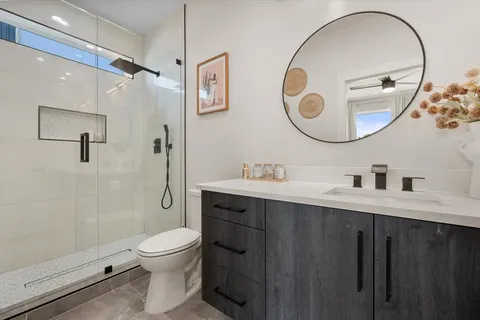 a bathroom with a toilet a sink and a mirror