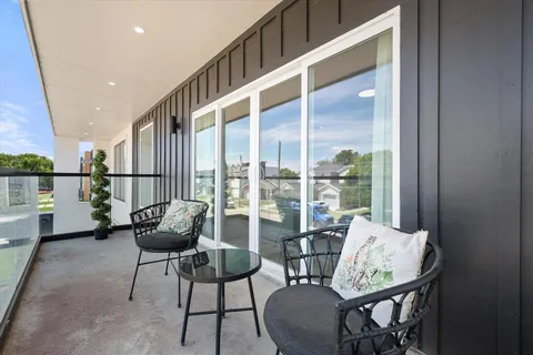 a balcony with furniture and a potted plant