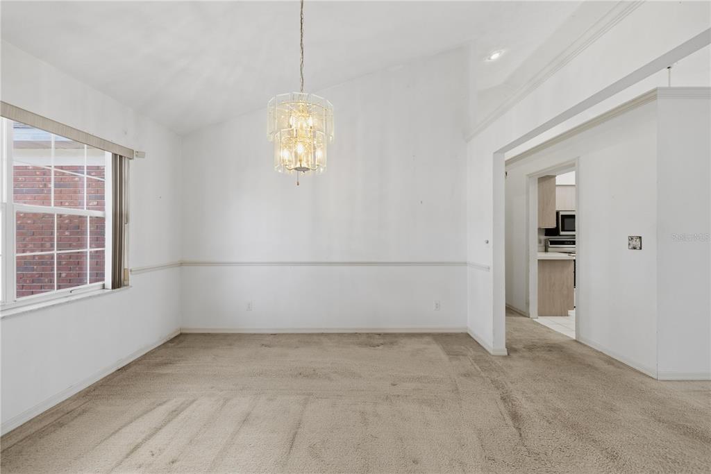 10660 Southwest 73rd Avenue Ocala, FL 34476 - Photo 13 of 37 wooden floor in an empty room with a window