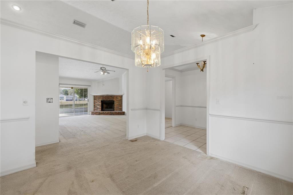 10660 Southwest 73rd Avenue Ocala, FL 34476 - Photo 14 of 37 en empty room with fireplace and windows