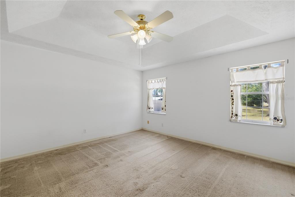 10660 Southwest 73rd Avenue Ocala, FL 34476 - Photo 15 of 37 an empty room with a window and a fan