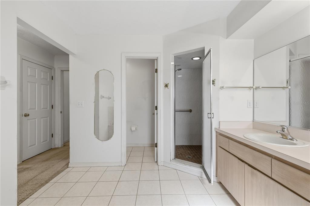 10660 Southwest 73rd Avenue Ocala, FL 34476 - Photo 19 of 37 a bathroom with a double vanity sink a shower and a mirror