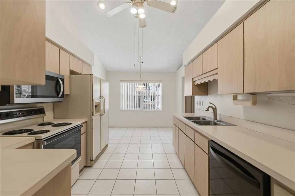 10660 Southwest 73rd Avenue Ocala, FL 34476 - Photo 21 of 37 a kitchen with stainless steel appliances a sink stove and refrigerator