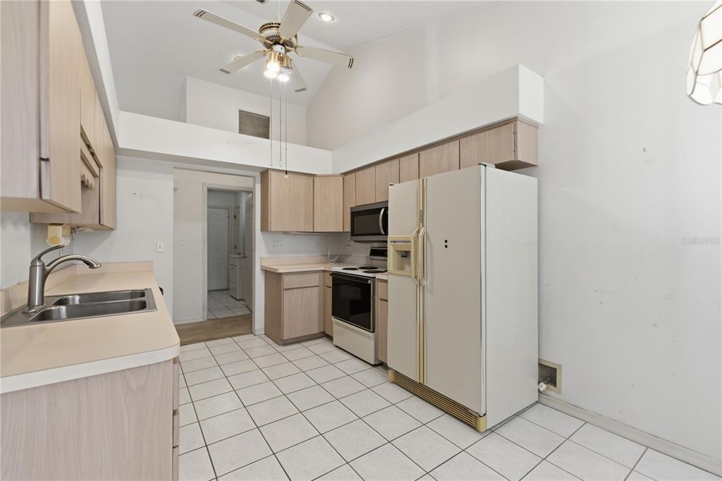 10660 Southwest 73rd Avenue Ocala, FL 34476 - Photo 22 of 37 a kitchen with a refrigerator a sink and dishwasher