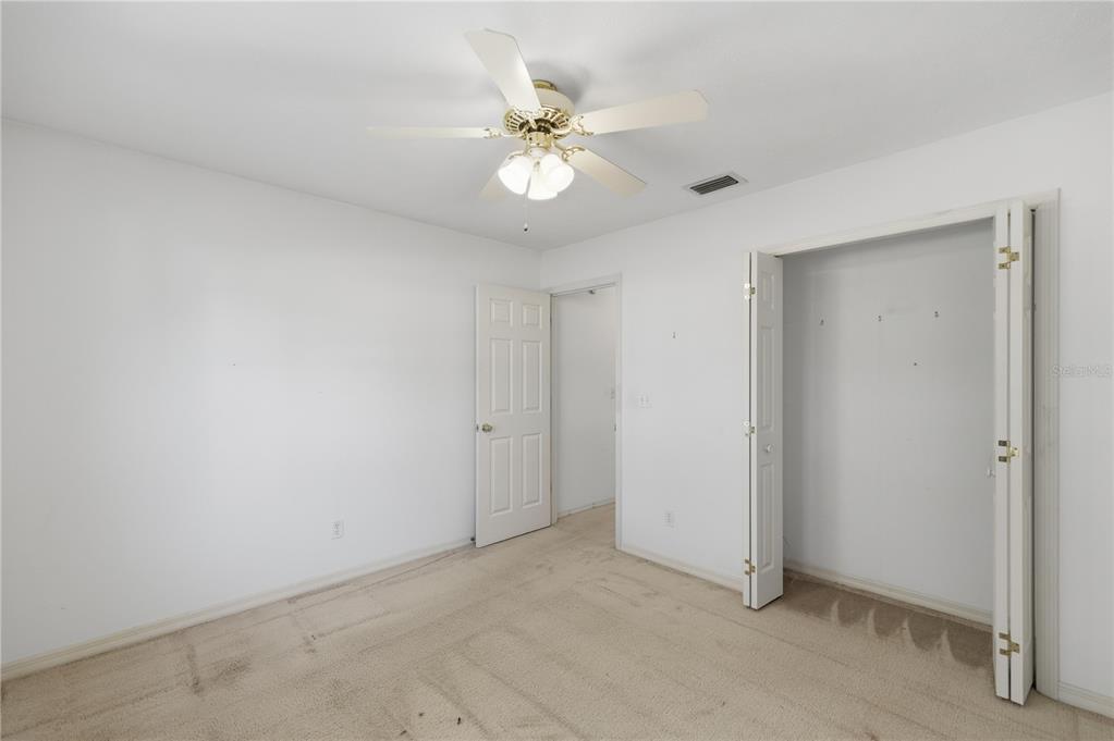 10660 Southwest 73rd Avenue Ocala, FL 34476 - Photo 25 of 37 a view of an empty room with a ceiling fan