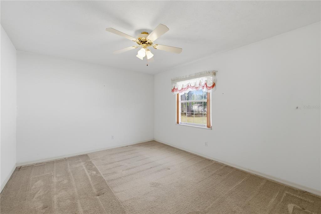 10660 Southwest 73rd Avenue Ocala, FL 34476 - Photo 27 of 37 an empty room with windows and fan