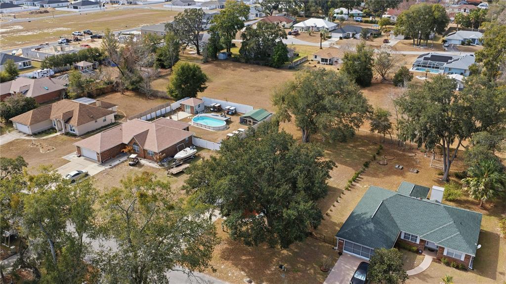 10660 Southwest 73rd Avenue Ocala, FL 34476 - Photo 32 of 37 an aerial view of a house with a yard lake and outdoor seating