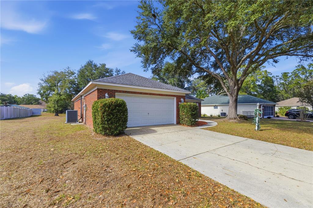 10660 Southwest 73rd Avenue Ocala, FL 34476 - Photo 4 of 37 a front view of a house with a yard and garage