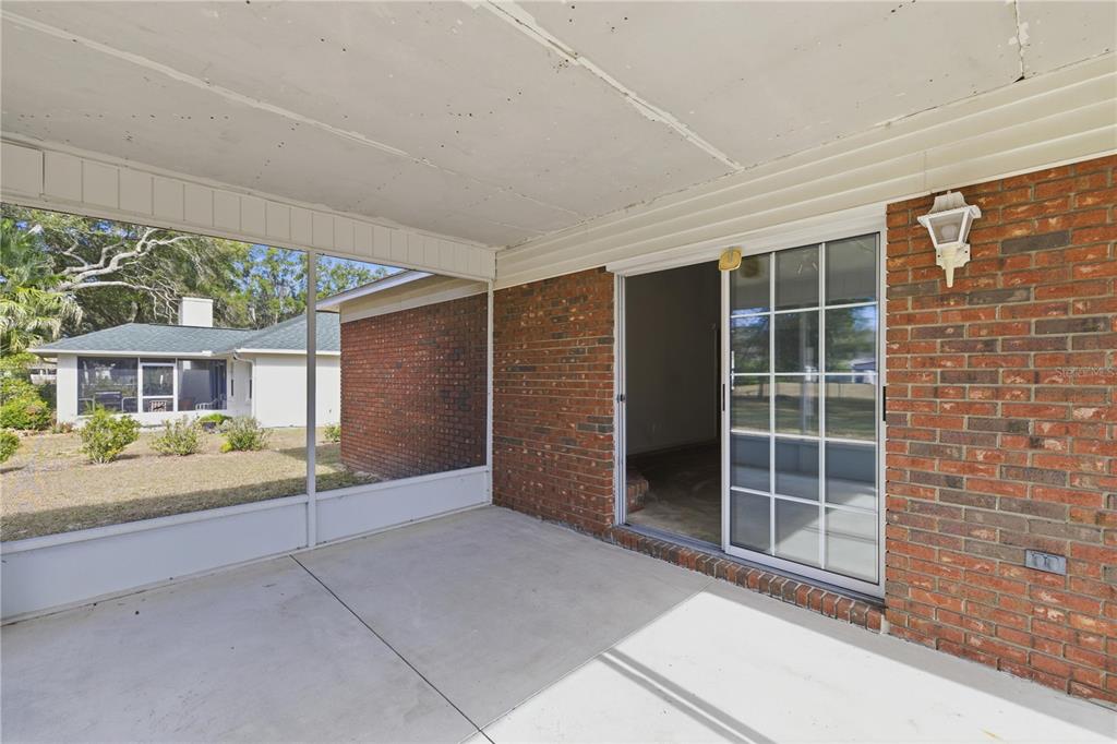 10660 Southwest 73rd Avenue Ocala, FL 34476 - Photo 6 of 37 a view of an empty room with a fireplace and a large window