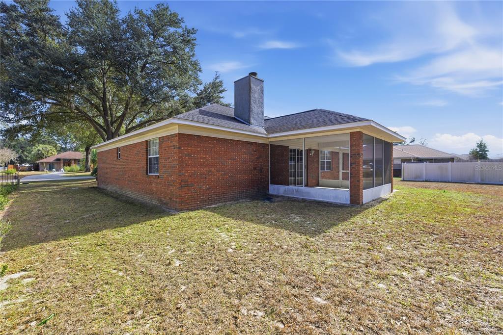 10660 Southwest 73rd Avenue Ocala, FL 34476 - Photo 7 of 37 a front view of a house with a yard
