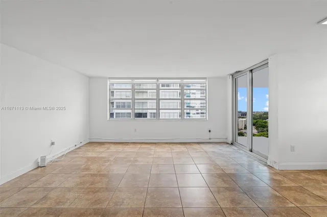 a view of an empty room with glass door
