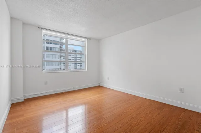 a bathroom with a granite countertop sink a shower and mirror