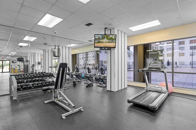 a dining room with furniture a rug and a floor to ceiling window