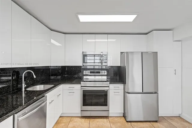 a kitchen with a refrigerator sink and stove