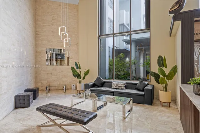 a view of a refrigerator in kitchen and an empty room in wooden floor