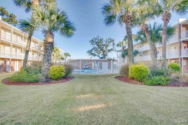 a view of a swimming pool with outdoor seating