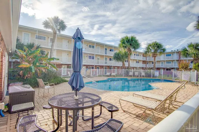 a view of a house with backyard and sitting area
