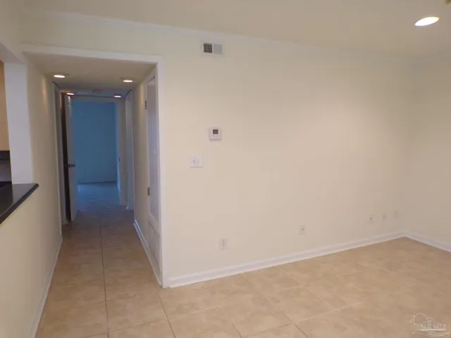a view of a chandelier fan and refrigerator