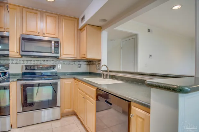 a kitchen with granite countertop white cabinets and a stove