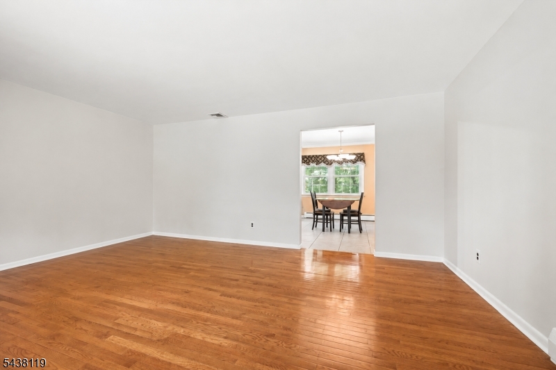 335 Drakestown Road Long Valley, NJ 07853 - Photo 7 of 34 a view of empty room with wooden floor and fan